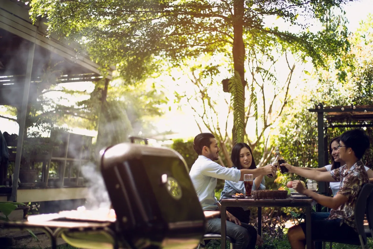 A man and woman sitting at an outdoor table.