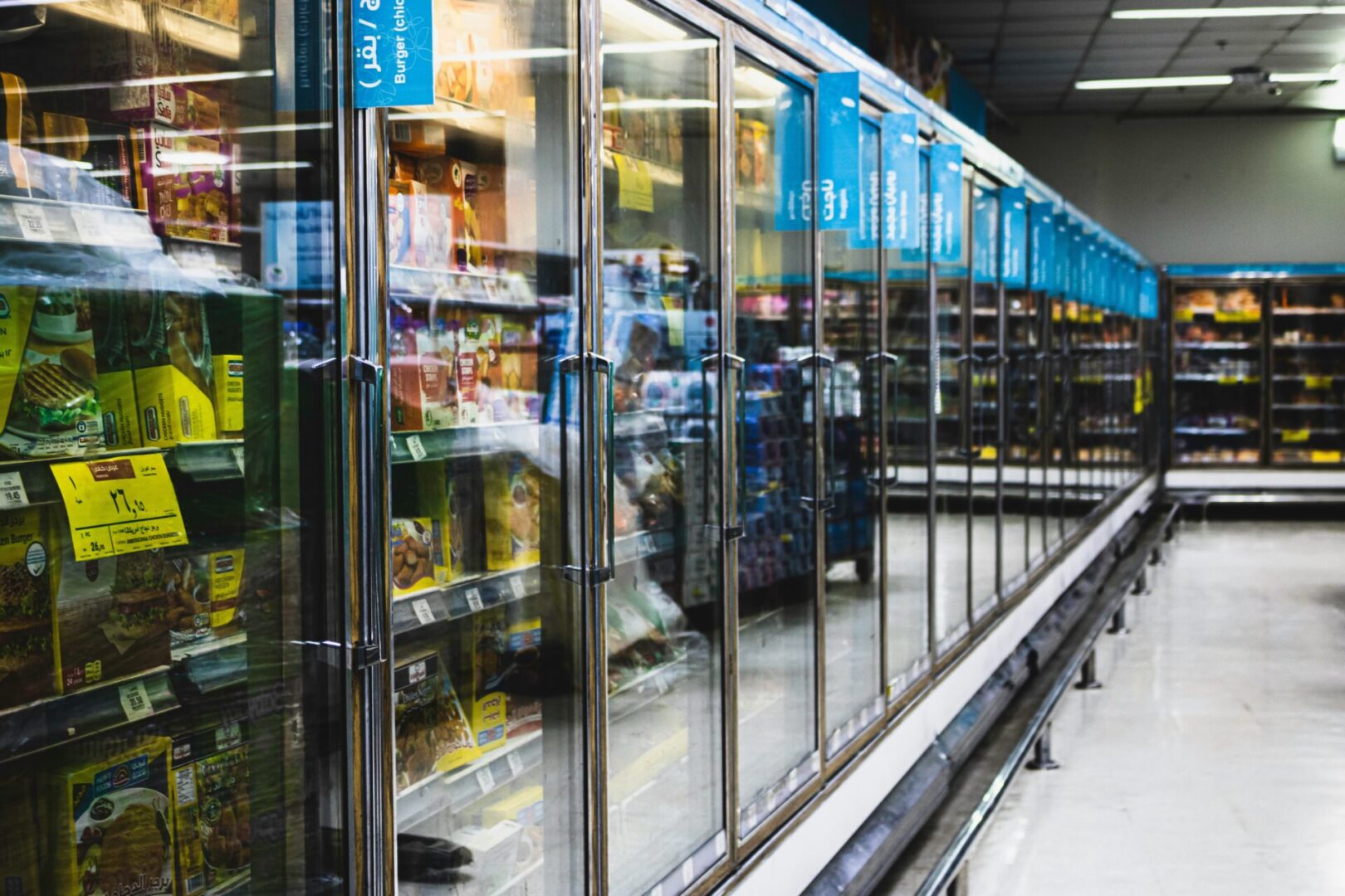 A store with many refrigerators and shelves of food.